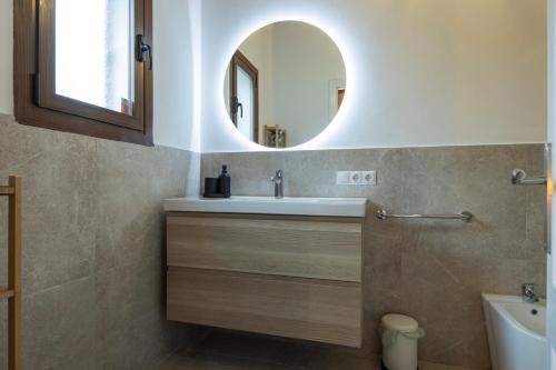 a bathroom with a sink and a mirror at Alcudia Beach House in Alcudia