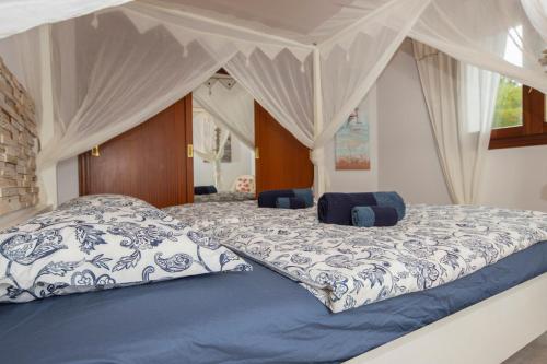 a bedroom with a large bed with a canopy at Alcudia Beach House in Alcudia