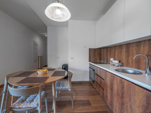 a kitchen with a table and a sink at Apartments Garden Azure Budva in Budva