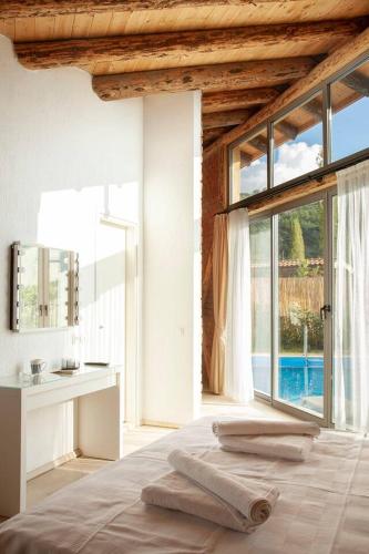 a bedroom with a bed and a large window at Villa Alaçatı (İslamlar-Kalkan) in Kaş