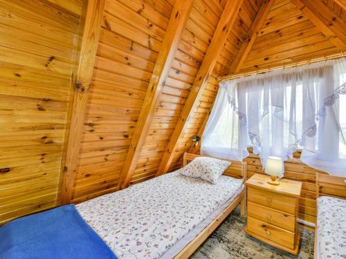 a bedroom with a bed in a wooden house at Holiday homes, Kolobrzeg in Kołobrzeg