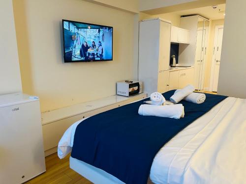 a bedroom with a large bed with towels on it at #Orbi-city in Batumi