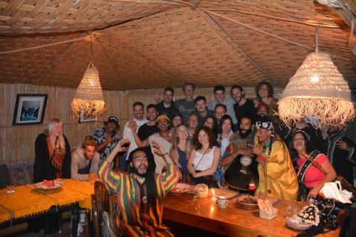 a group of people posing for a picture in a room at Taghazout Roof Hostel in Taghazout