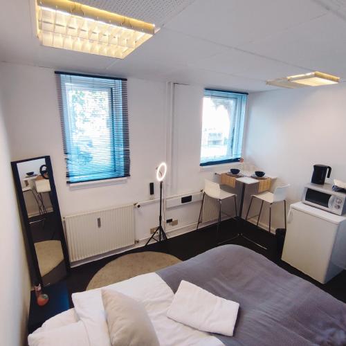 a bedroom with a bed and a table and chairs at Functional studio/room Copenhagen in Copenhagen