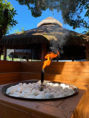 a fire pit with a candle on top of it at Essência do Sol Pousada in Florianópolis