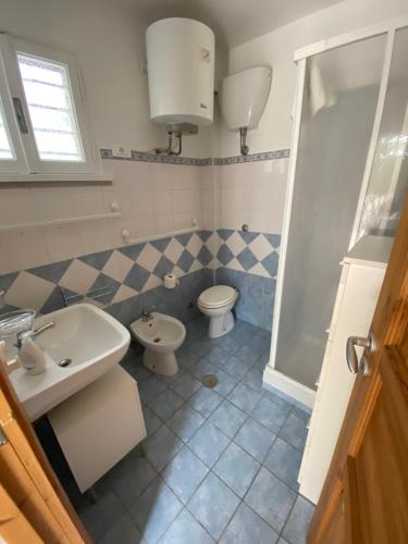 a bathroom with a sink and a toilet at La Casetta delle sirene Anzio in Anzio