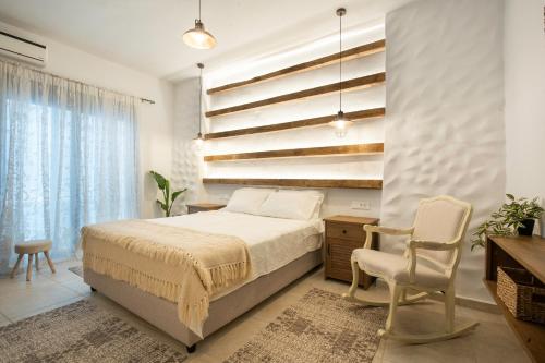 a bedroom with a bed and a desk and a chair at Mareò Traditional Retreat in Archangelos