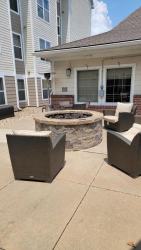 a patio with two chairs and a fire pit at Residence Inn Kansas City Independence in Independence