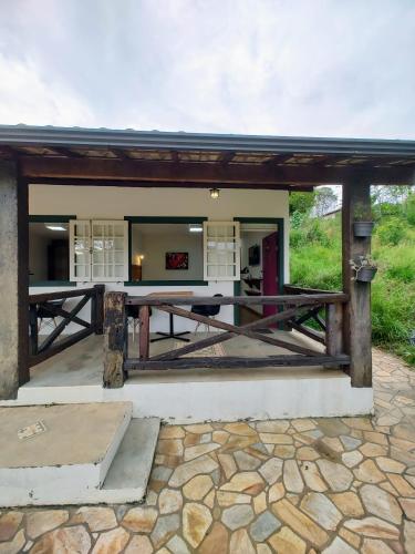 a pavilion with a table in front of a building at Recanto Serra do Trovão in Ouro Preto