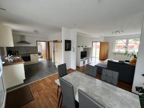 a kitchen and living room with a table and a couch at Ferienwohnung Neubörger mit Hottub in Neubörger