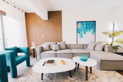 a living room with a couch and a table at LOFTS by Elegant Hospitality in Cairo