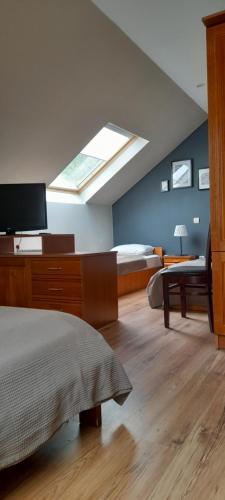a bedroom with a bed and a skylight at Family Hotel Pchelina in Rilski Manastir