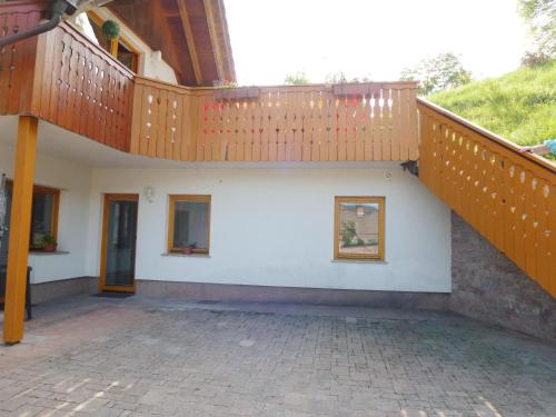 a house with a staircase and a patio at Apartment Jalps 3 in beautiful Bohinjska Bistrica in Bohinj