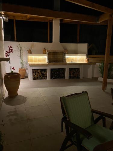 a patio with a couch and a chair and a table at Avli House Vori in Vóroi