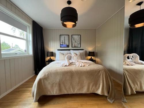 a bedroom with a bed with towels on it at Bratsberg Apartment - with Kitchenette and Free Parking in Trondheim