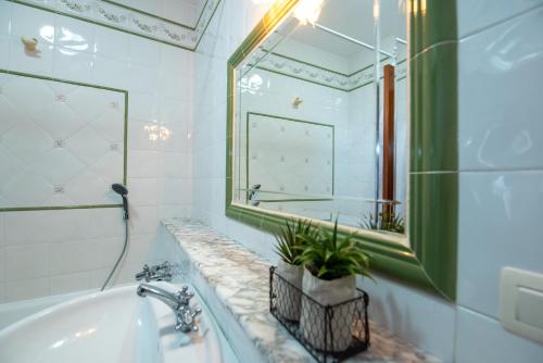 a bathroom with a tub and a sink and a mirror at LAR DA REVOLTA in Cedeira