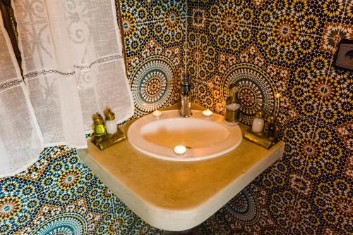 a bathroom with a sink with candles on it at Riad Bianca Marrakech in Marrakesh