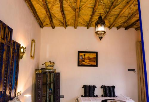 a room with a table and a chandelier on the wall at Riad Bianca Marrakech in Marrakesh