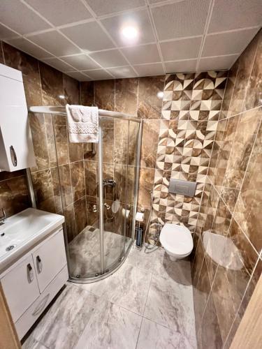 a bathroom with a shower and a toilet at Fengo Hotel & Spa in Trabzon