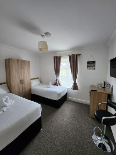 a hotel room with two beds and a window at Park View room with free minibar tea&coffee in Dublin