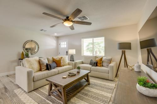 a living room with a couch and a ceiling fan at Near Peoria Sports Complex and Golf Home with Patio! in Sun City