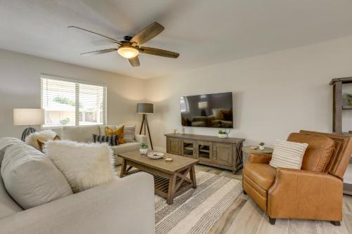 a living room with a couch and a tv at Near Peoria Sports Complex and Golf Home with Patio! in Sun City