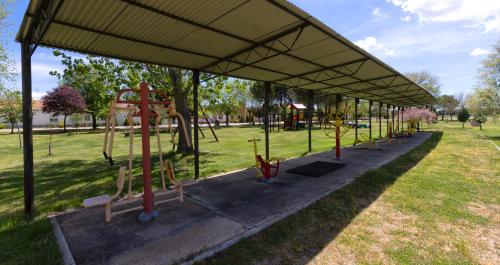 a playground in a park with a pavilion at Las Casas de Pecheye in Bocigas