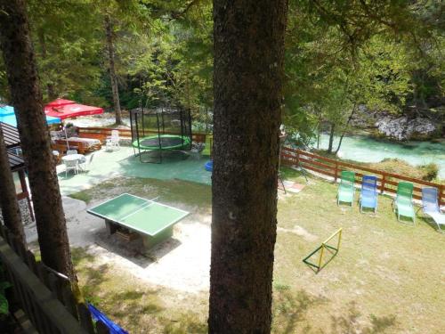 a view of a playground with a picnic table and chairs at Apartmaji in Sobe Cuder in Soča