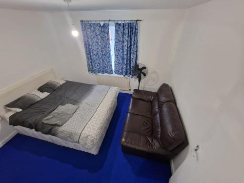 a small bedroom with a bed and a window at Room in a shared Flat in London