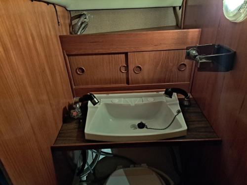a bathroom with a sink on a wooden table at Unique boat in Höganäs