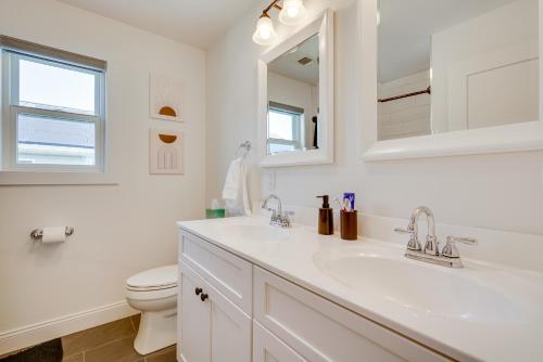 a white bathroom with a sink and a toilet at Gorgeous Keansburg Home with Pool Walk to Beach! in Keansburg