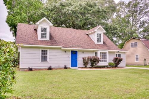 a white house with a blue door at Charleston Vacation Rental with Yard! in Charleston