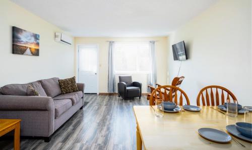 a living room with a couch and a table at Hebridean Motel in Port Hood