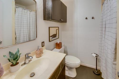 a bathroom with a sink and a toilet and a mirror at Renovated San Marcos Vacation Rental with Balcony! in San Marcos