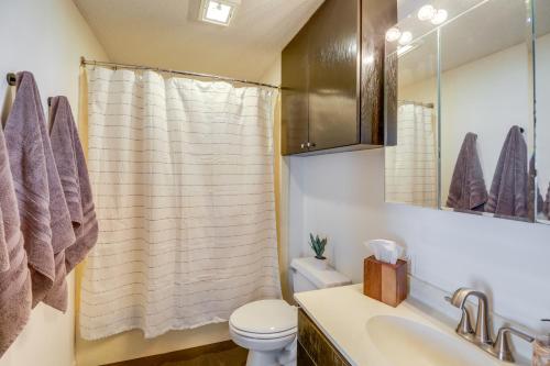 a bathroom with a toilet and a sink and a mirror at Renovated San Marcos Vacation Rental with Balcony! in San Marcos