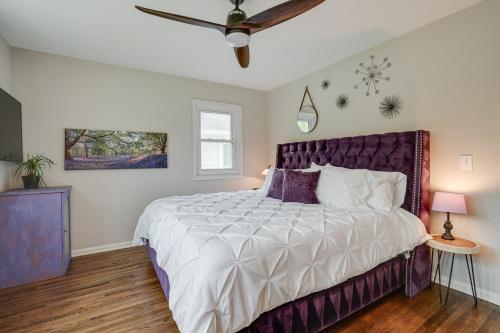 a bedroom with a large bed with a purple headboard at Pet-Friendly Minneapolis Home about 8 Mi to Downtown! in Minneapolis
