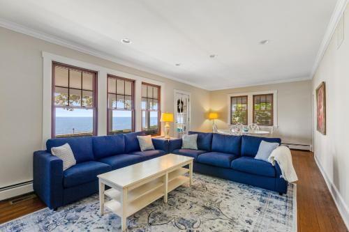 a living room with blue couches and a table at The Salty Crab in Annapolis