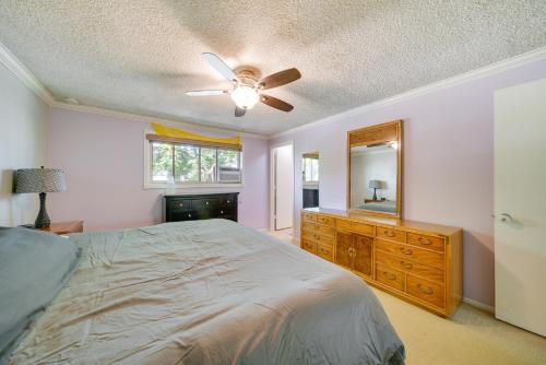 a bedroom with a bed and a dresser and a mirror at Vancouver Vacation Rental about 16 Mi to Portland! in Vancouver