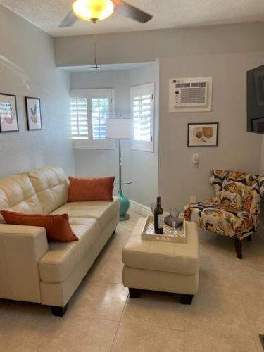 a living room with a white couch and a chair at Hideaway in the Heart of Phoenix with POOL in Phoenix