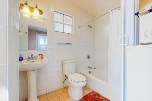 a bathroom with a toilet and a sink and a shower at Sunshine Casita in Key West
