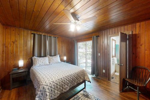 a bedroom with a bed and a ceiling fan at The Little Brick Cottage in Myrtle Beach