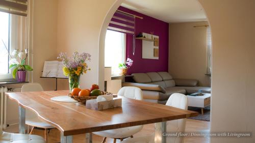 a living room with a table with a bowl of fruit at Entire House in Schwarzwald with mountain view, private Sauna, Gym, Garden and Terraces in Unterkirnach