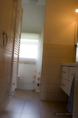 a small bathroom with a window and a shower at Entire House in Schwarzwald with mountain view, private Sauna, Gym, Garden and Terraces in Unterkirnach