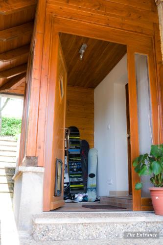 a door to a room with a snowboard in it at Entire House in Schwarzwald with mountain view, private Sauna, Gym, Garden and Terraces in Unterkirnach