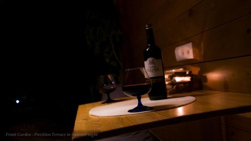 a bottle of wine and a glass on a counter at Entire House in Schwarzwald with mountain view, private Sauna, Gym, Garden and Terraces in Unterkirnach