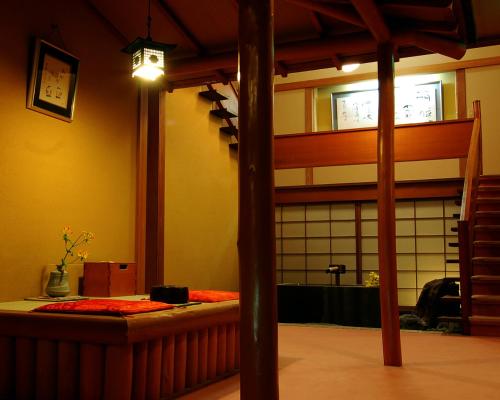 a room with a bed and a large window at Shin Kadoya in Atami
