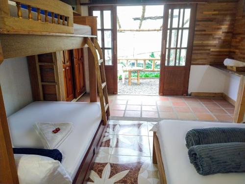 a room with two bunk beds and a hallway at Casa Viva Alojamiento Rural in Jardin
