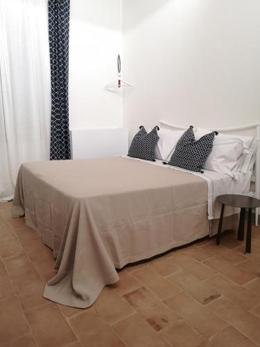 a white bed with two pillows on it in a room at MontepulcianoLettings in Montepulciano
