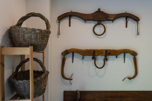 two wicker baskets and a shelf on a wall at Il giaggiolo in Reggello