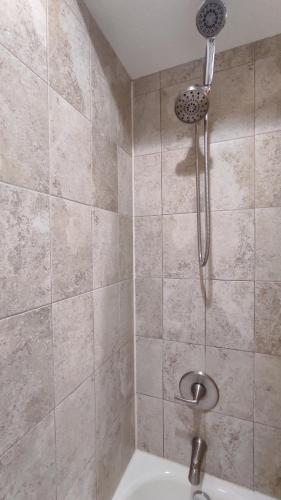 a shower with a shower head in a bathroom at 2BR / 2BA Apartment Sienna Park. in Sarasota